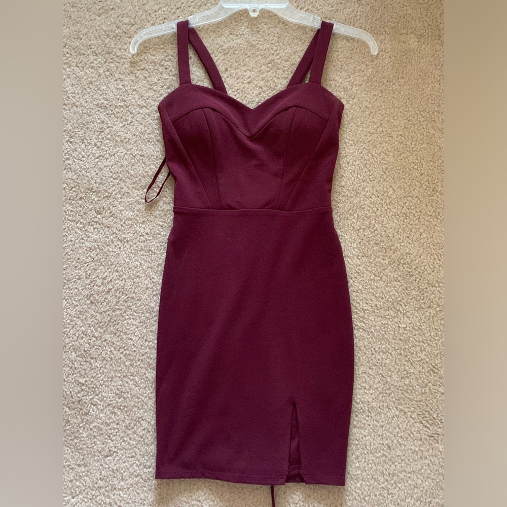 Maroon bodycon mini dress with lace up back and little slit on bottom left.
